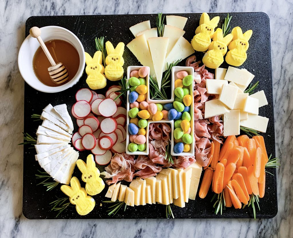 charcuterie board with easter candy on a marble background
