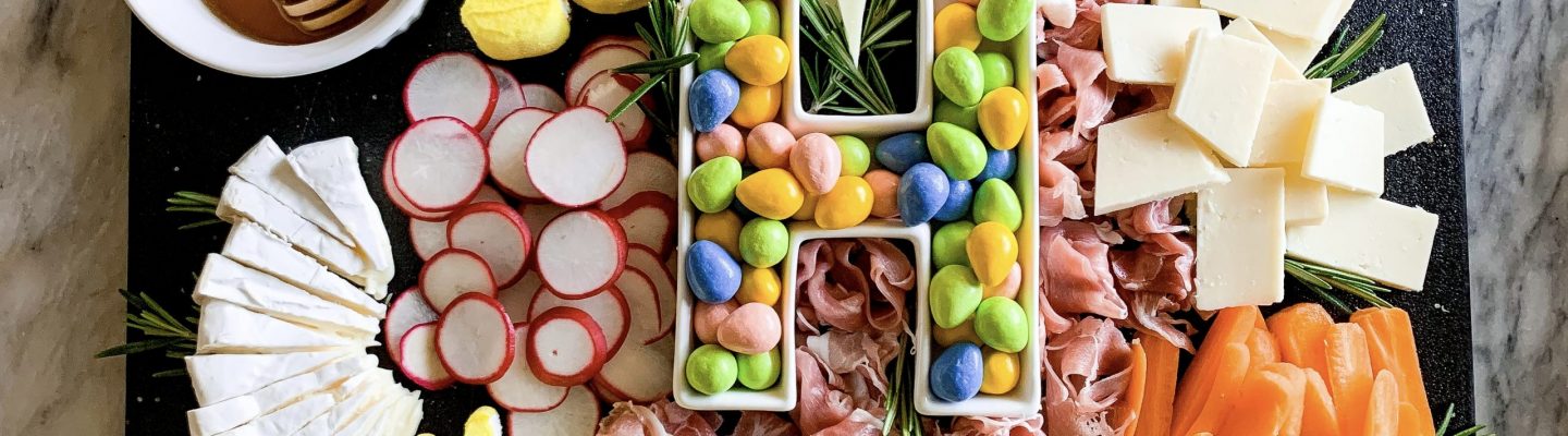 charcuterie board with easter candy on a marble background