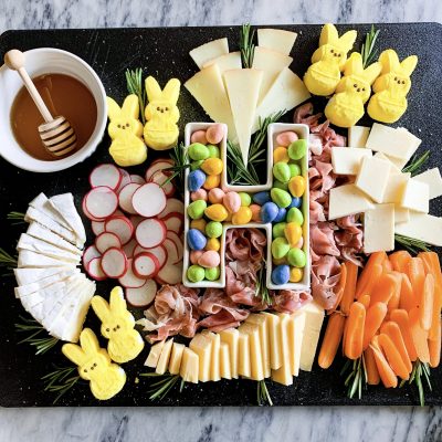 charcuterie board with easter candy on a marble background