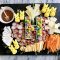 charcuterie board with easter candy on a marble background